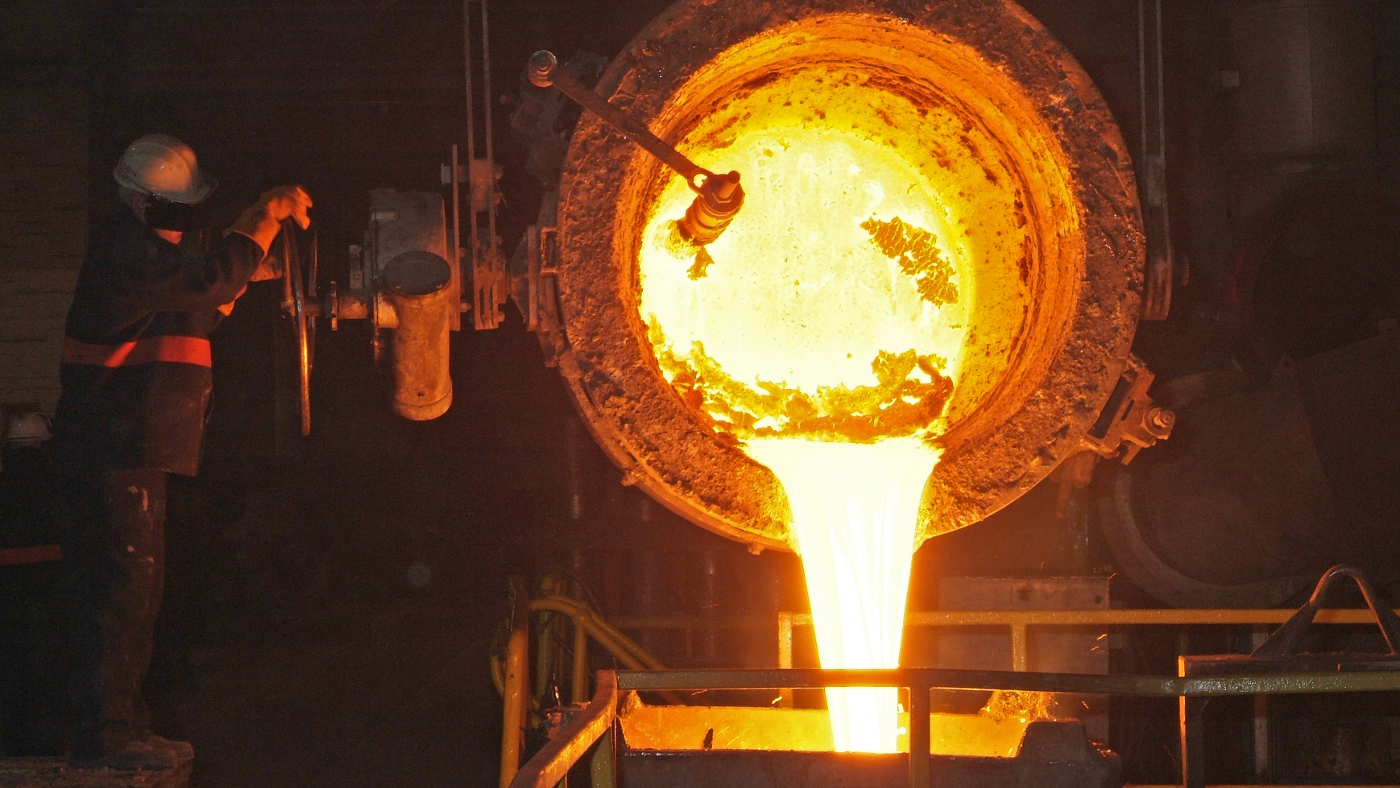 Worker pouring molten metal